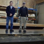 2 men standing on lightweight heavy duty glavanized steel magnetic panel 20 ft span