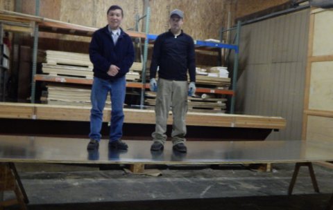 2 men standing on lightweight heavy duty glavanized steel magnetic panel 20 ft span