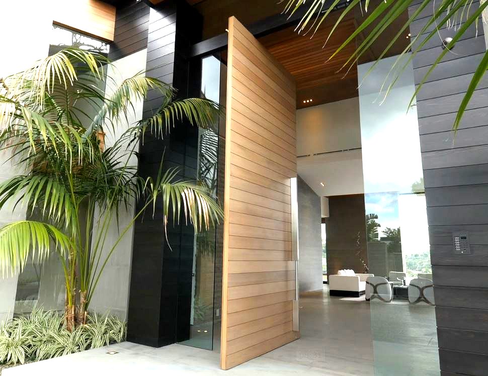 16 ft. teak wood pivot front door in billionaire's home with Sing Core inside